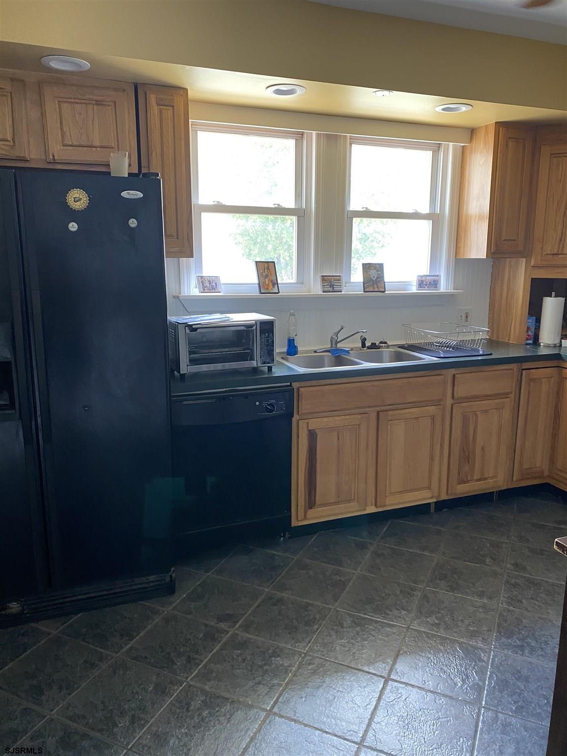 237 Marlin Road Absecon, NJ 08201 - Photo 9 of 25 a kitchen with a sink window and cabinets