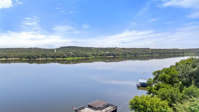 a view of a lake with houses in the back