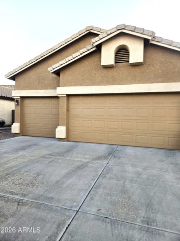 a living room with furniture a flat screen tv and a wall painting