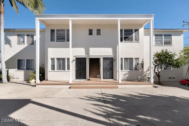 a front view of a house with a small yard