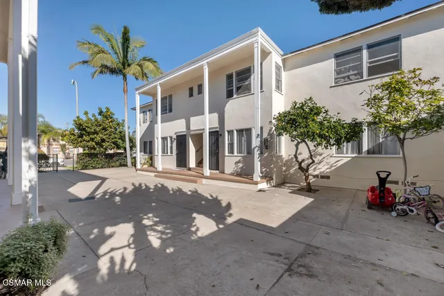 a view of a street with potted plants