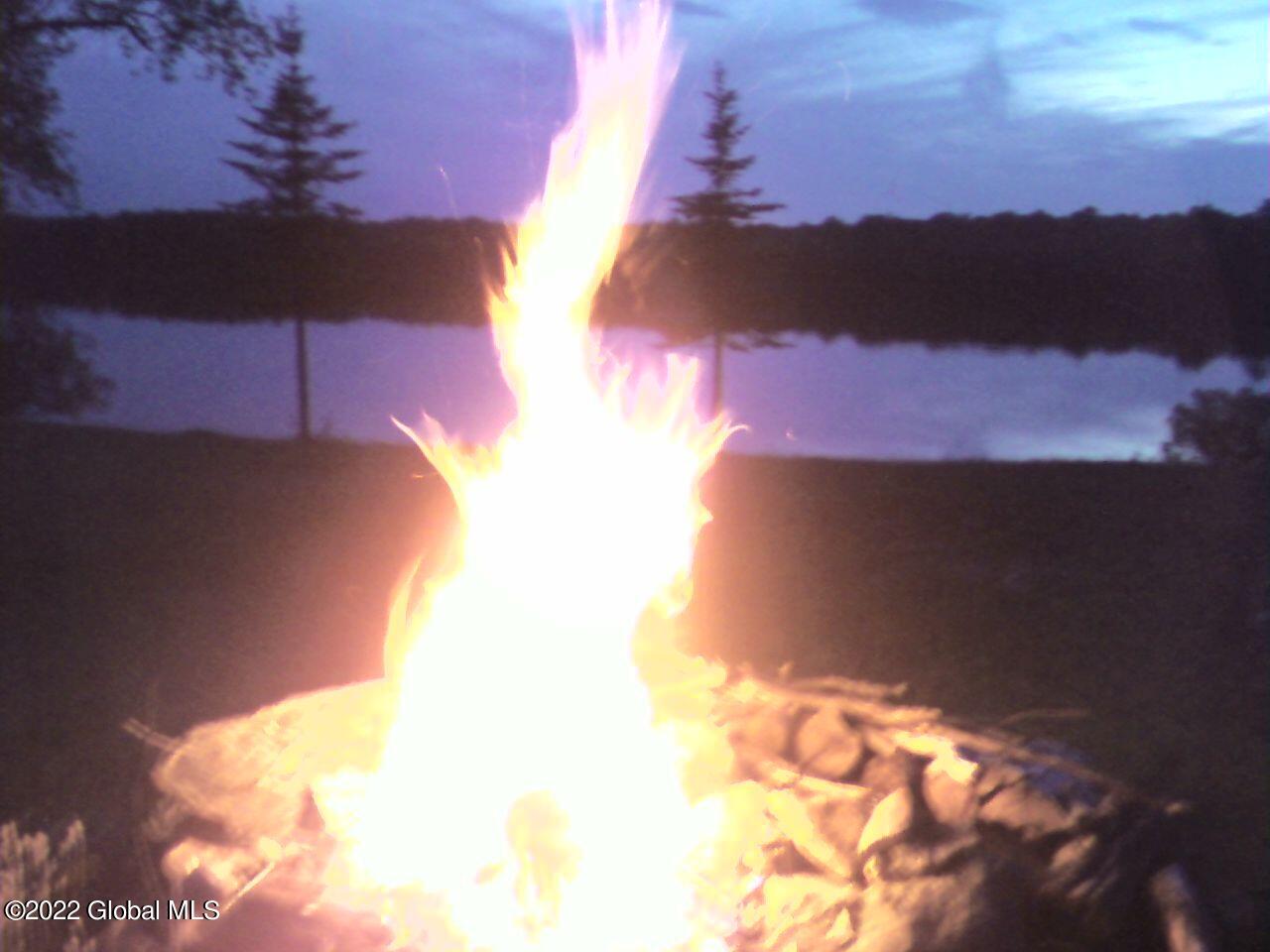 528 Dyken Pond Road Berlin, NY 12138 - Photo 59 of 100 campfire w lake in bkground
