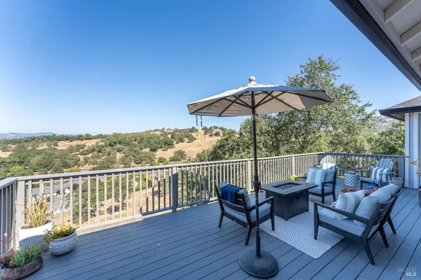a view of balcony with furniture and wooden deck