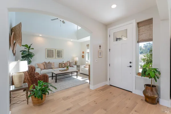 a living room with furniture potted plant and a window