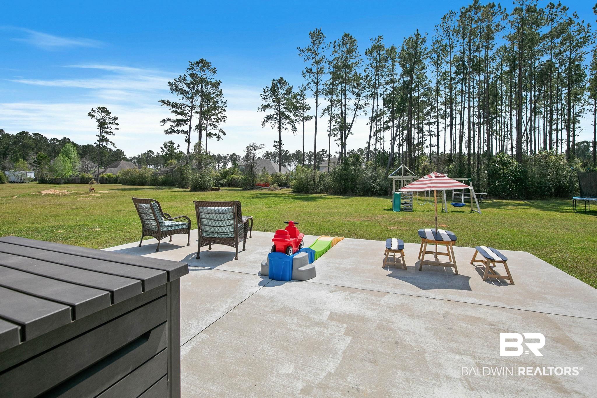 12750 B Jenkins Pit Road Daphne, AL 36527 - Photo 57 of 89 View of patio / terrace with a trampoline and a playground