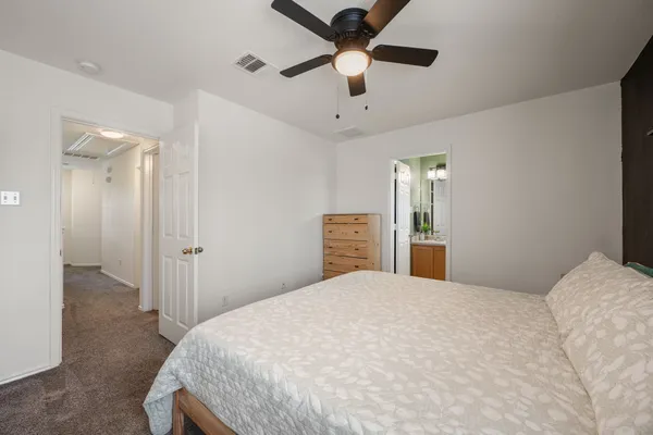 a bedroom with a large bed and a chandelier