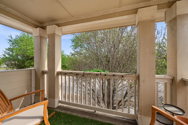 a view of a balcony with wooden floor