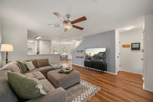 a living room with furniture and a chandelier