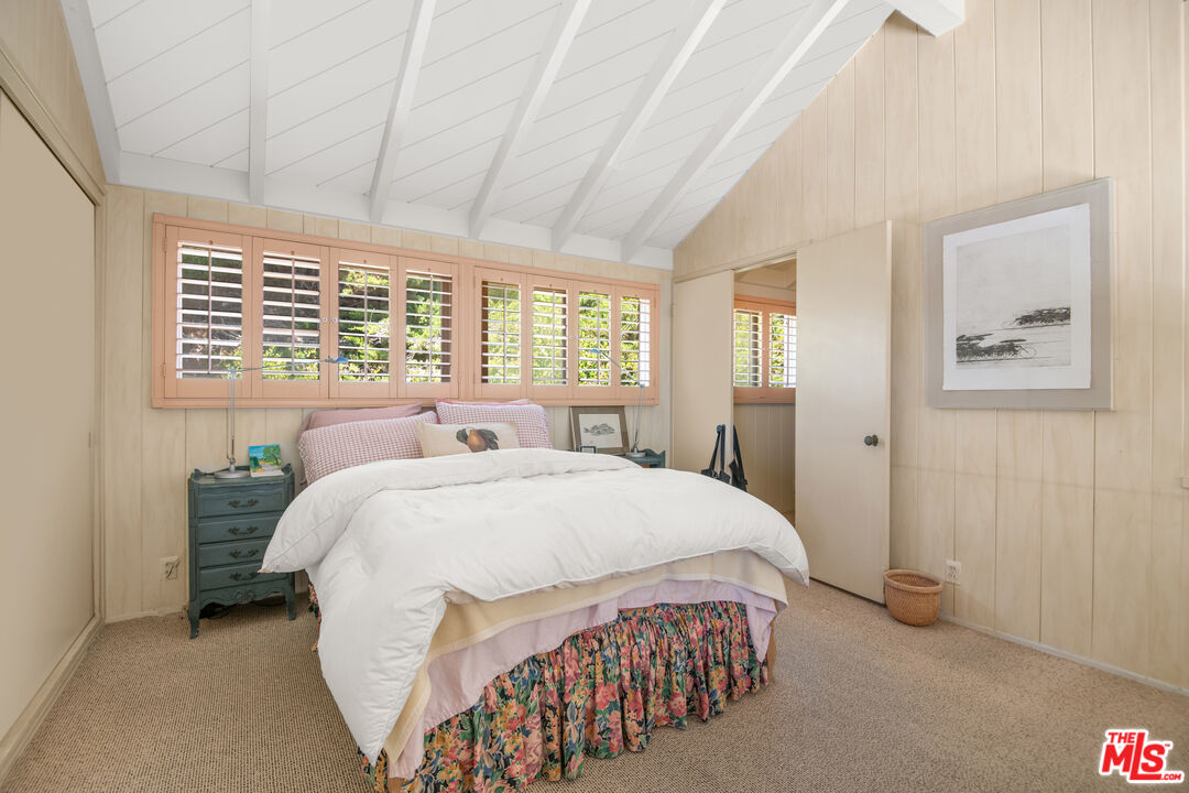 31649 Sea Level Drive Malibu, CA 90265 - Photo 13 of 26 a bedroom with a bed and glass windows