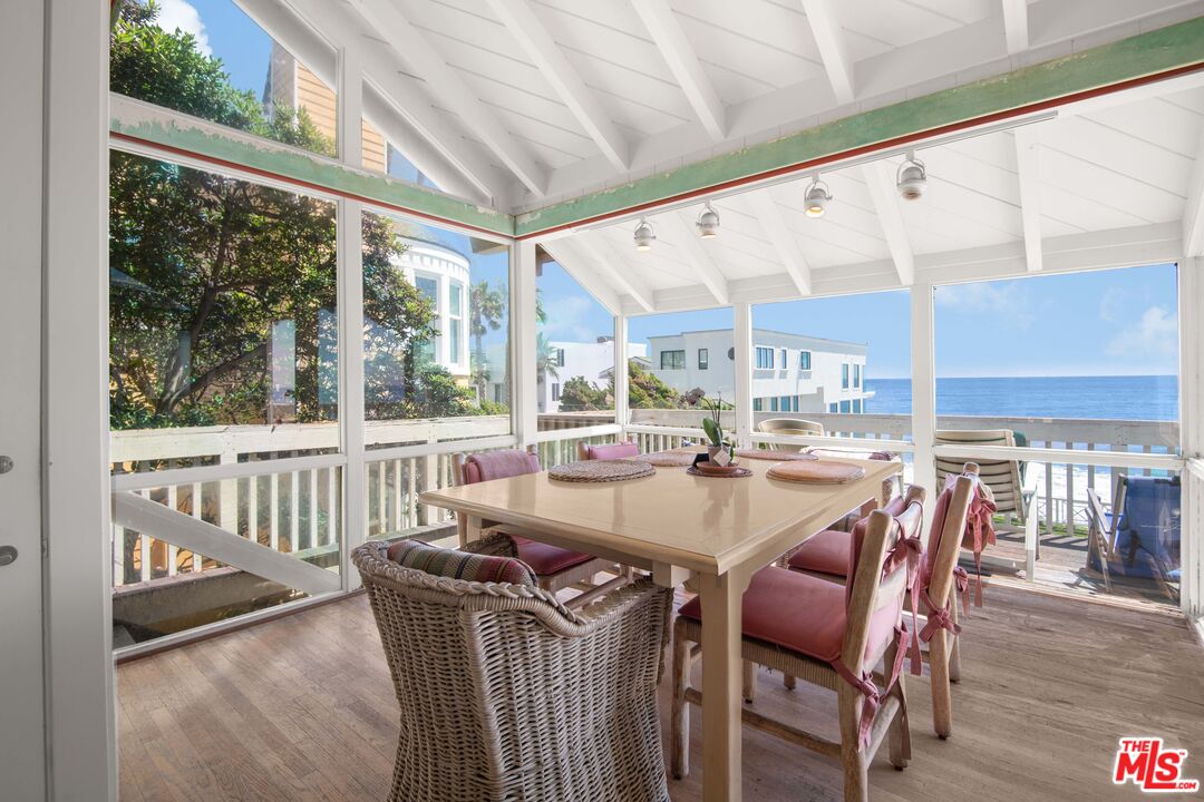 31649 Sea Level Drive Malibu, CA 90265 - Photo 5 of 26 a dining room with furniture a floor to ceiling window and wooden floor