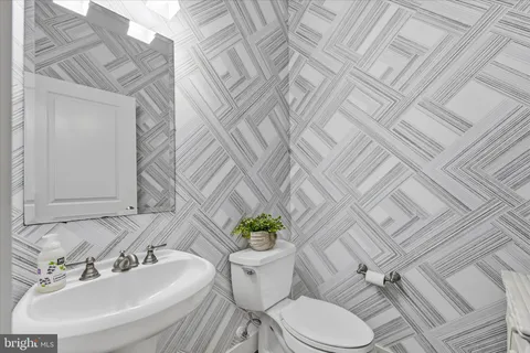 a bedroom with a large bed and ceiling fan