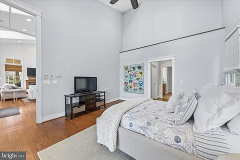 a bedroom with a bed a table and a window