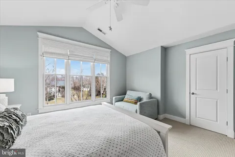 a living room with furniture and floor to ceiling windows