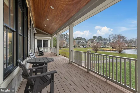 a living room with furniture and floor to ceiling windows