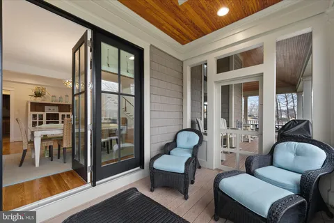 a view of a swimming pool with a lawn chairs and a fire pit