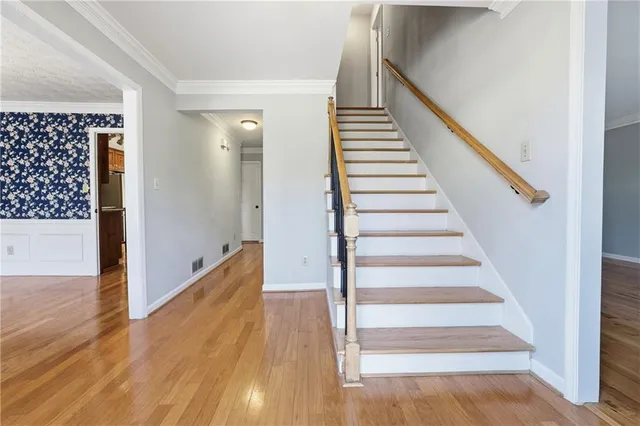 a view of entryway and gallery with wooden floor