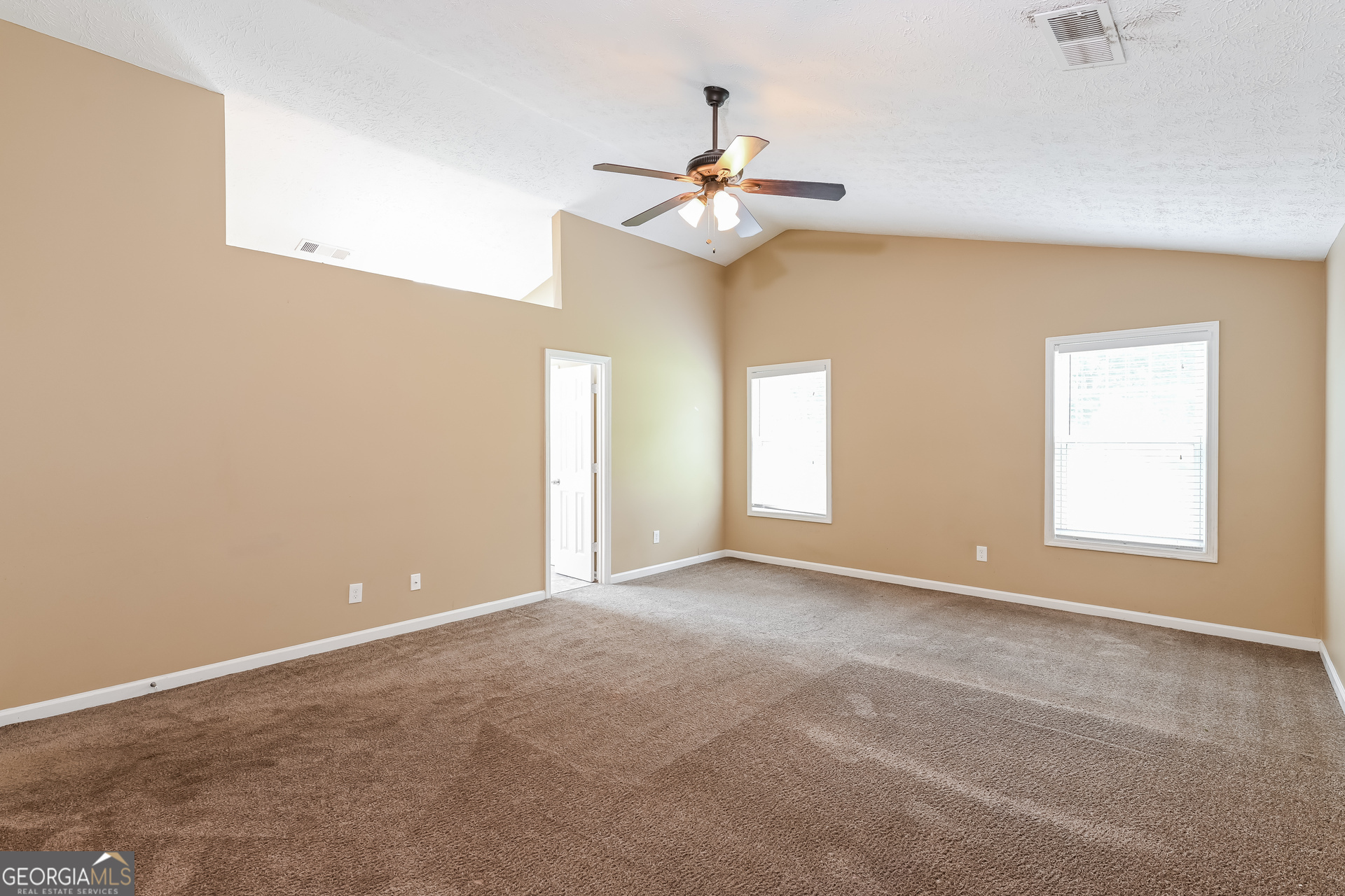 1684 Summit Pl Way Loganville, GA 30052 - Photo 11 of 17 an empty room with windows and fan