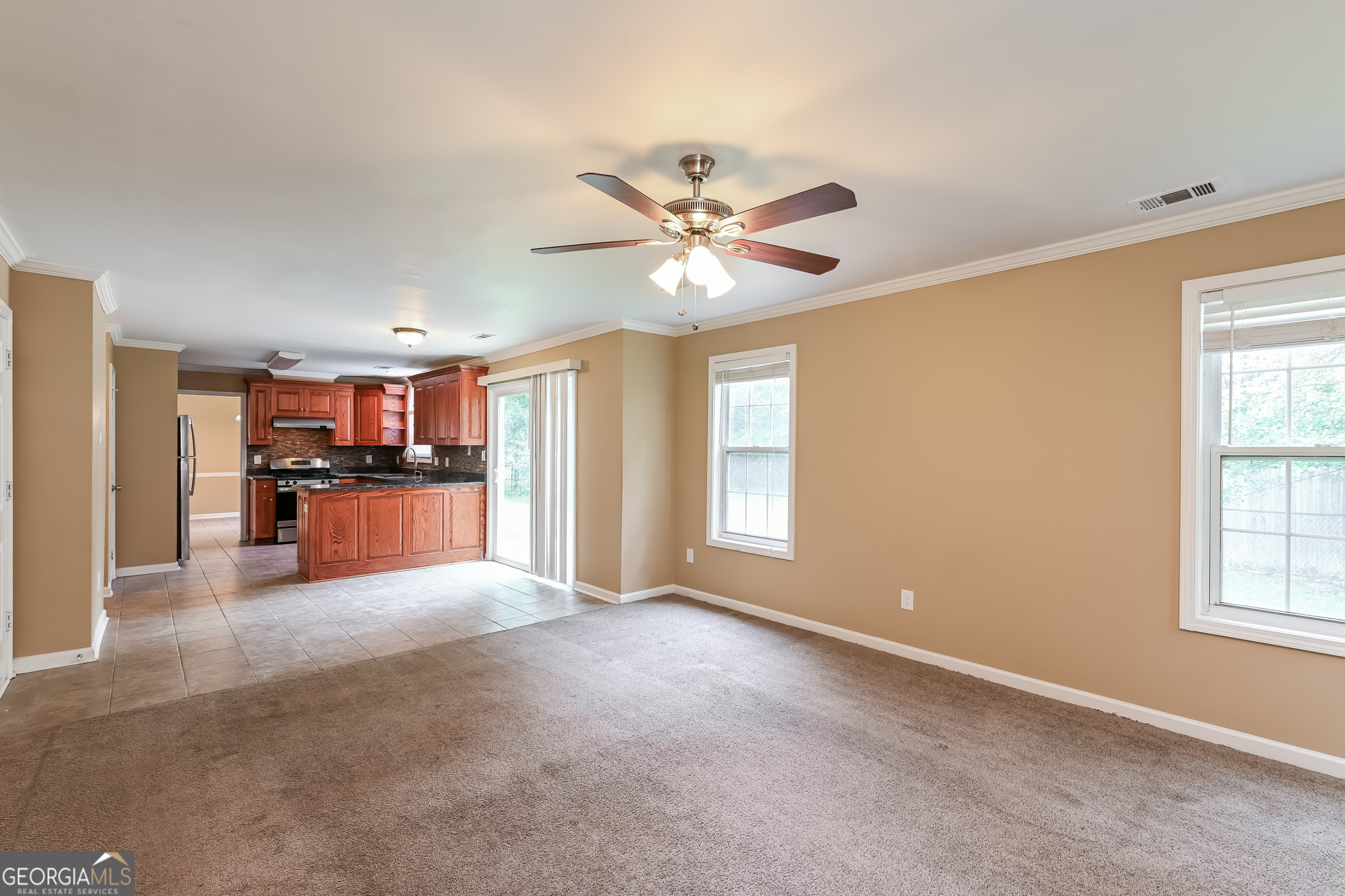1684 Summit Pl Way Loganville, GA 30052 - Photo 5 of 17 a view of a livingroom with a kitchen stove closet and window