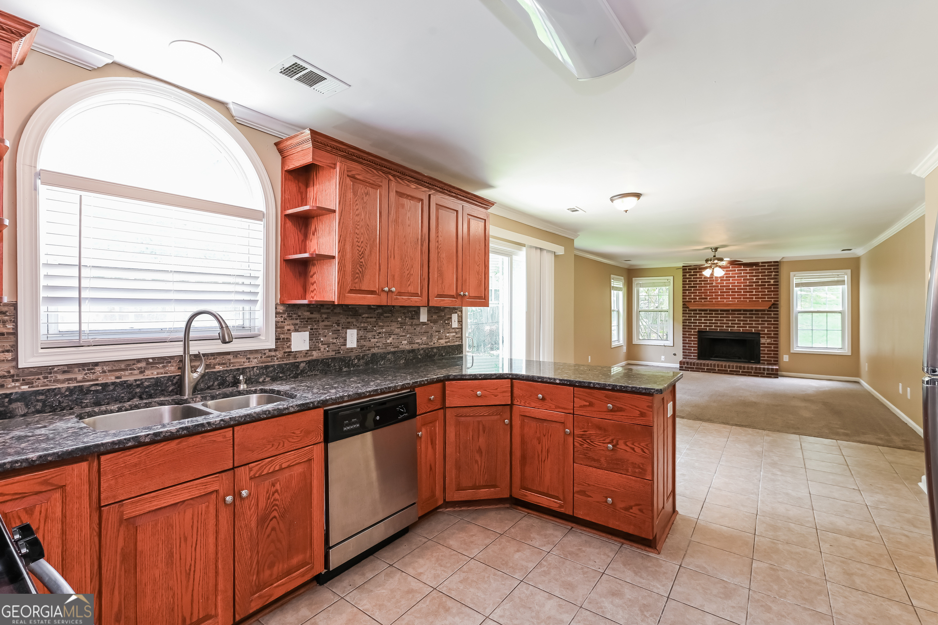 1684 Summit Pl Way Loganville, GA 30052 - Photo 7 of 17 a kitchen with stainless steel appliances granite countertop a sink and cabinets