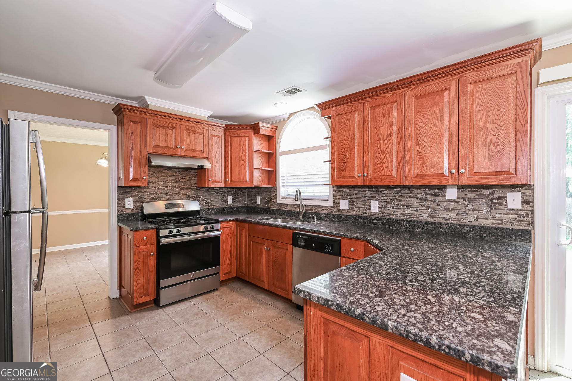 1684 Summit Pl Way Loganville, GA 30052 - Photo 8 of 17 a kitchen with stainless steel appliances granite countertop a stove a sink dishwasher and a refrigerator