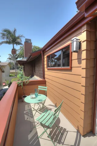 a balcony with table and chairs