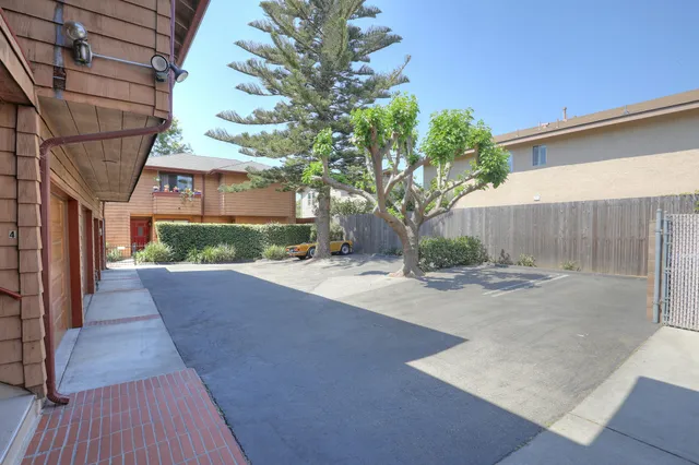 a view of a house with a tree and a yard