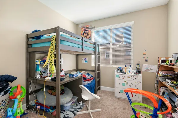 a bedroom with a bed and a painting on the wall