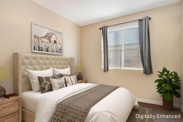 a bedroom with a bed a books bucket with a desk and chair