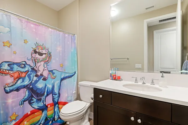 a view of sign board with buildings and yard