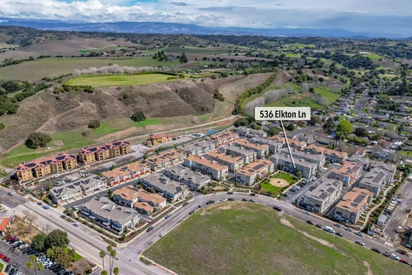 an aerial view of residential houses with outdoor space