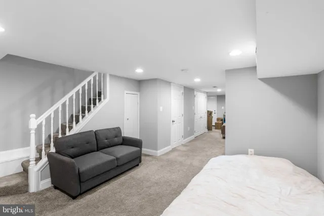 a living room with furniture and a ceiling fan