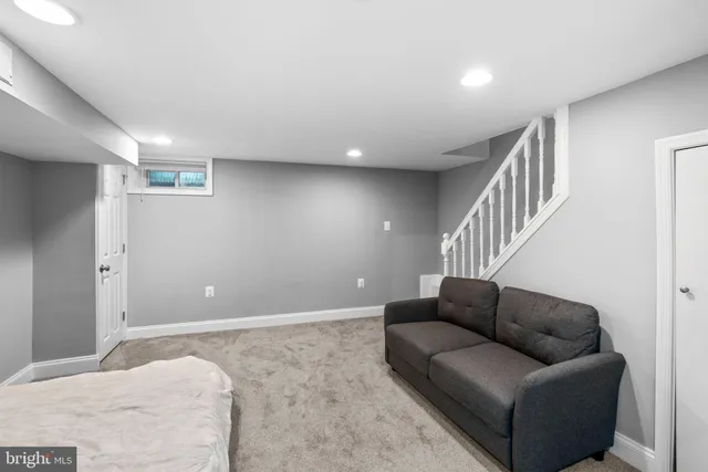 a living room with furniture and stairs