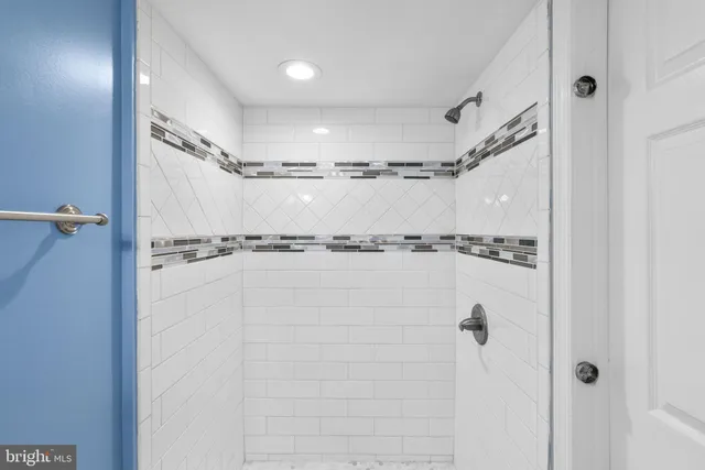 a bathroom with a shower and a shower
