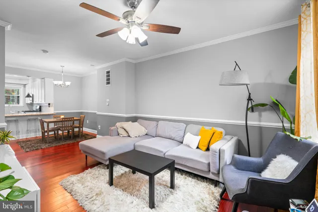 a living room with furniture and kitchen view