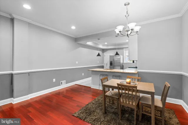 a view of a dining room with furniture and chandelier