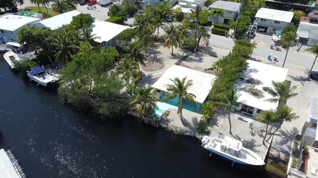 an aerial view of a house with yard swimming pool and outdoor seating