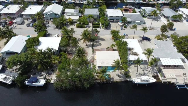 an aerial view of a house with a yard basket ball court and outdoor seating