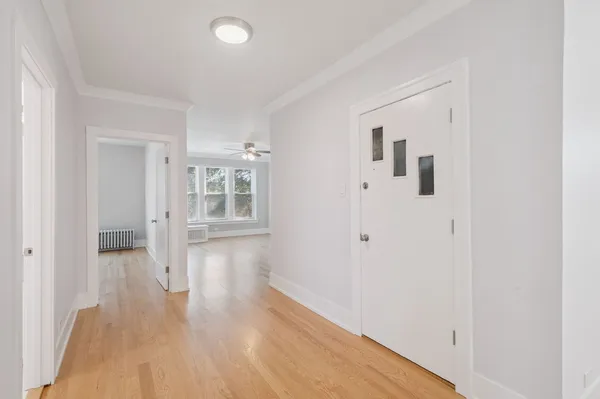 a view of a hallway with wooden floor