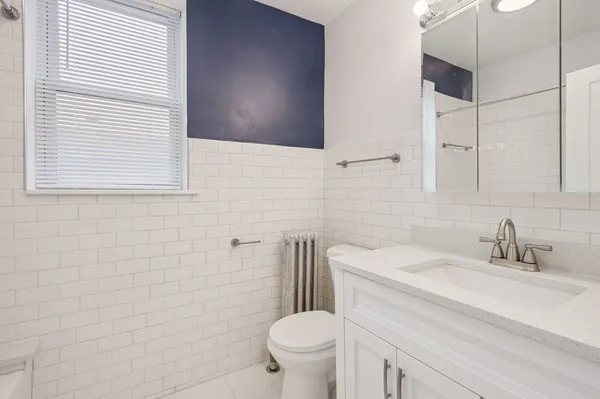 a bathroom with a sink a toilet and a mirror