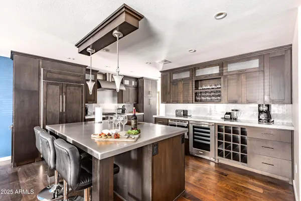a kitchen with sink refrigerator and cabinets