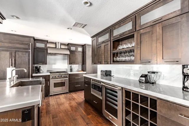 a kitchen with stainless steel appliances granite countertop a stove sink and cabinets
