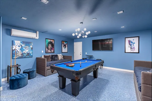 a living room with furniture and a chandelier