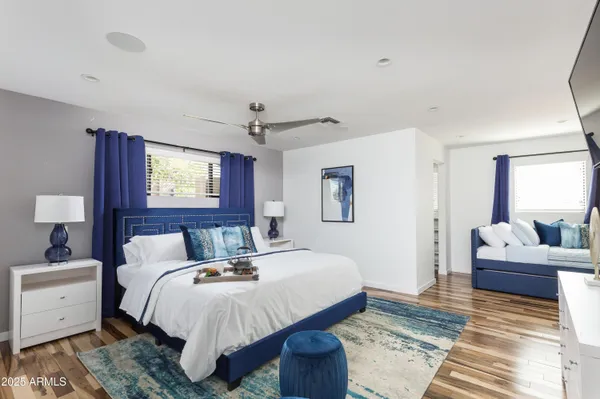 a bedroom with a bed and wooden floor