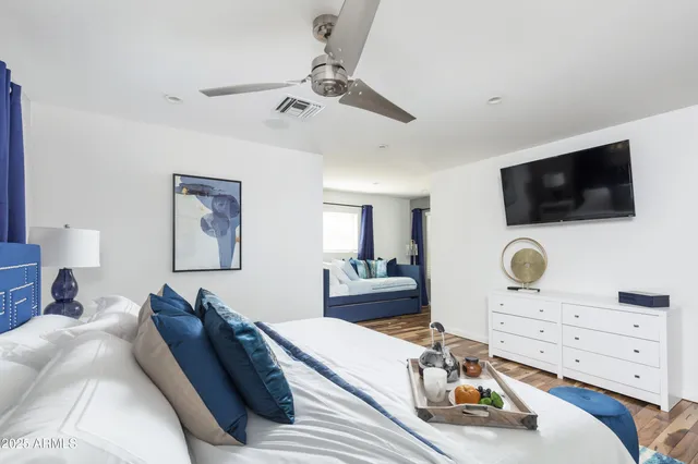 a bedroom with a bed and flat screen tv