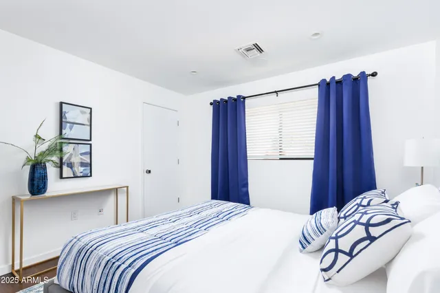 a bedroom with a bed and a window