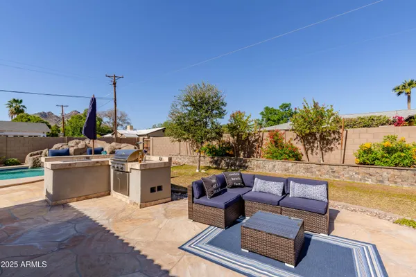 a view of a backyard with sitting area