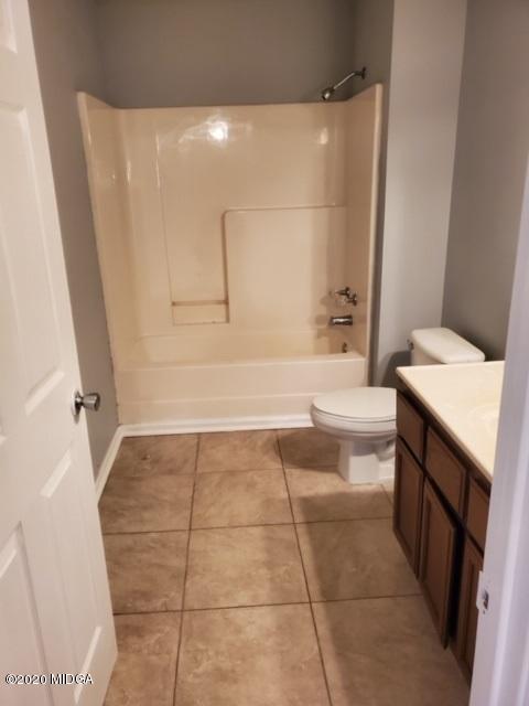 2154 Taylors Mill Road Fort Valley, GA 31030 - Photo 12 of 17 a bathroom with a bathtub a toilet a sink and a shower
