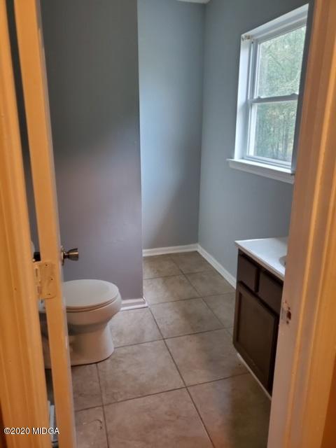 2154 Taylors Mill Road Fort Valley, GA 31030 - Photo 13 of 17 a bathroom with a granite countertop toilet and a sink