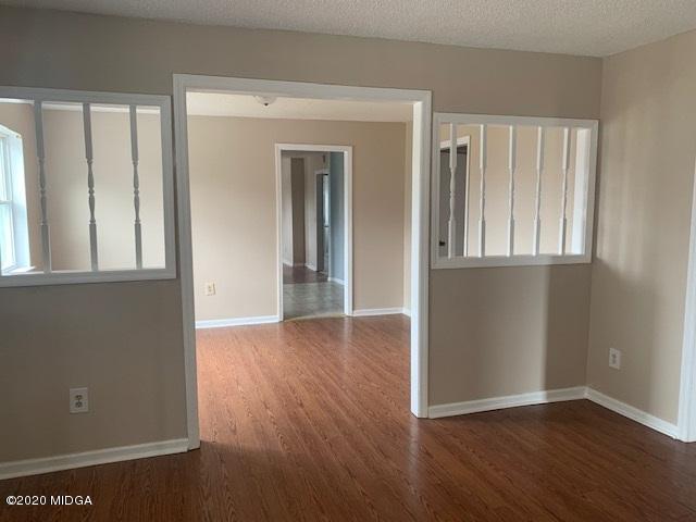 2154 Taylors Mill Road Fort Valley, GA 31030 - Photo 5 of 17 an empty room with wooden floor and windows