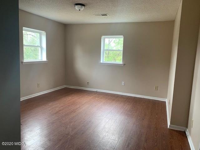 2154 Taylors Mill Road Fort Valley, GA 31030 - Photo 8 of 17 an empty room with wooden floor and a window